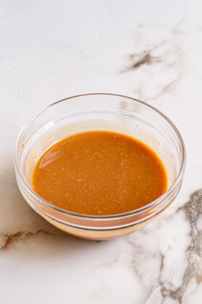 melted peanut butter, coconut oil, maple syrup, and pure vanilla extract in a glass bowl.