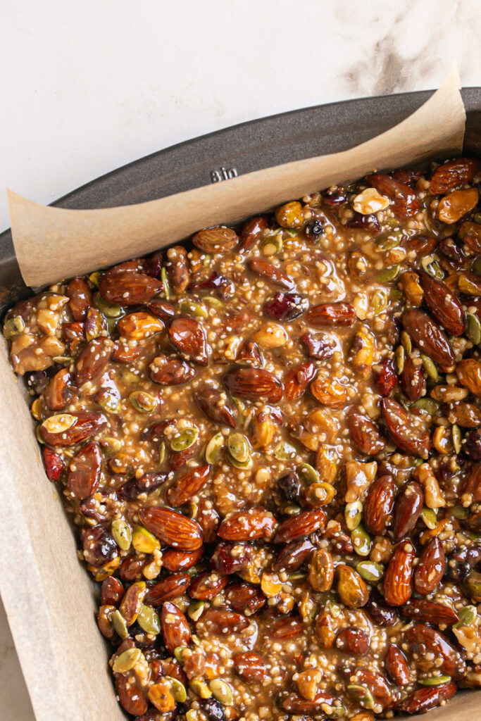 the trail mix bars spread in a baking pan.