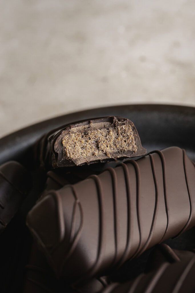 close up of the inside of a crispy peanut butter protein chocolate candy bar.