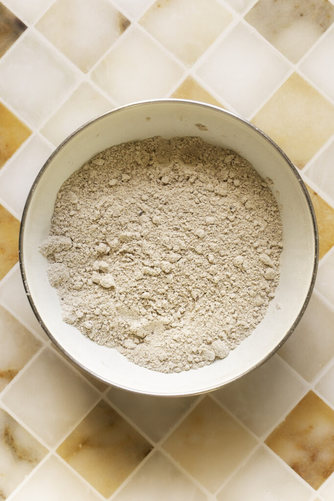 dry ingredients used to make these mini apple cider banana bread muffins mixed together in a bowl.