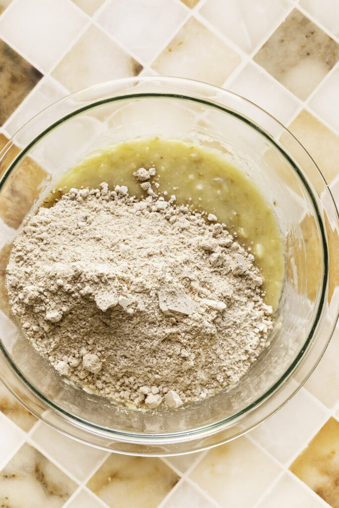 flour mixture in the bowl with the mashed bananas.