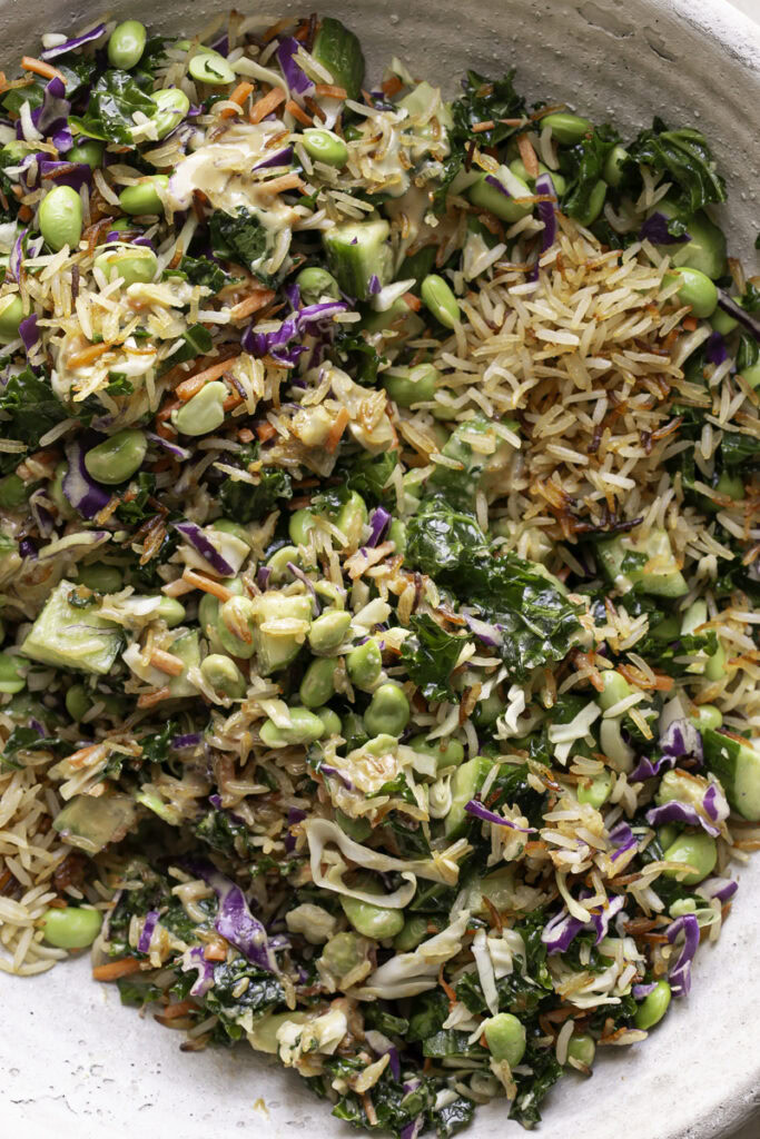 salad ingredients tossed together in a large bowl.