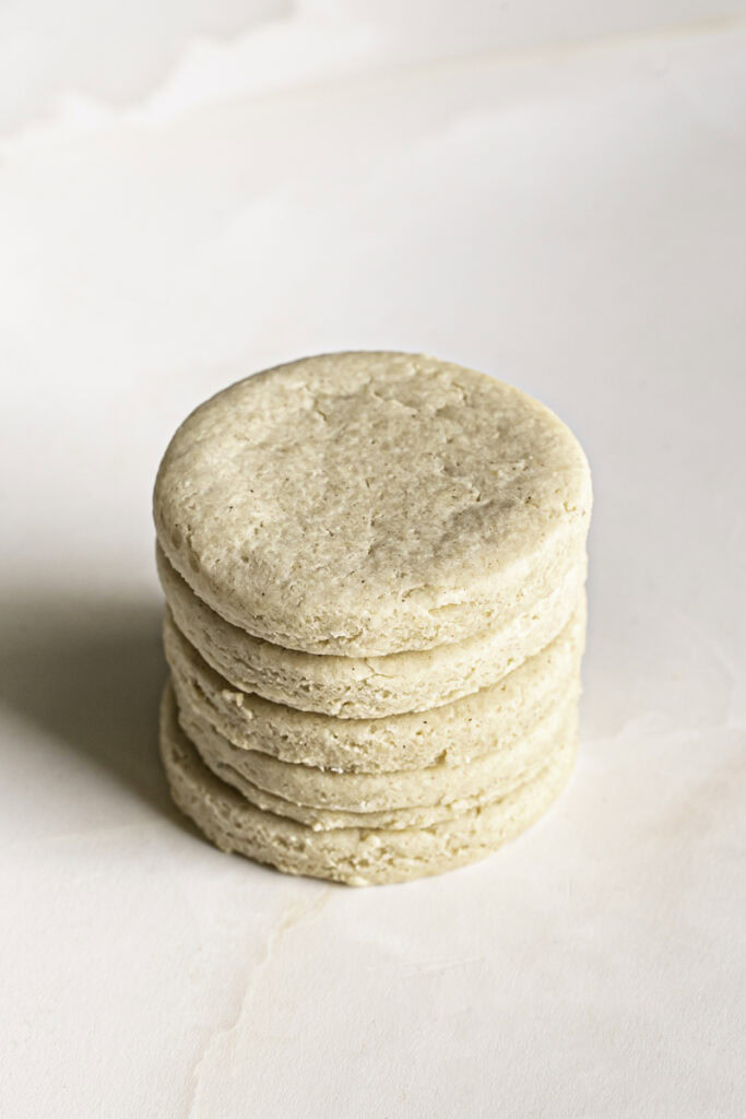 5 baked, unfrosted soft sugar cookies stacked on top of each other.