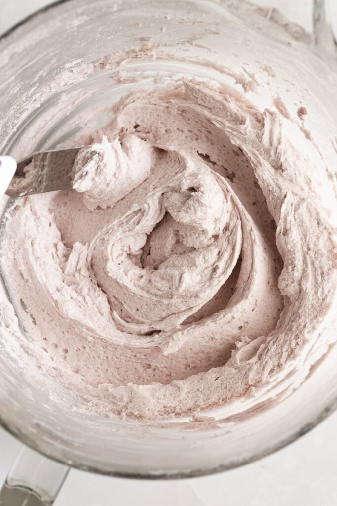 a bowl of pink buttercream frosting.