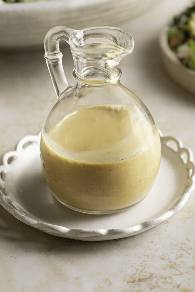 sesame miso carrot dressing in a glass bottle.