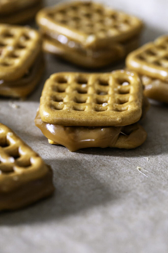 melted caramel in between two pretzels.