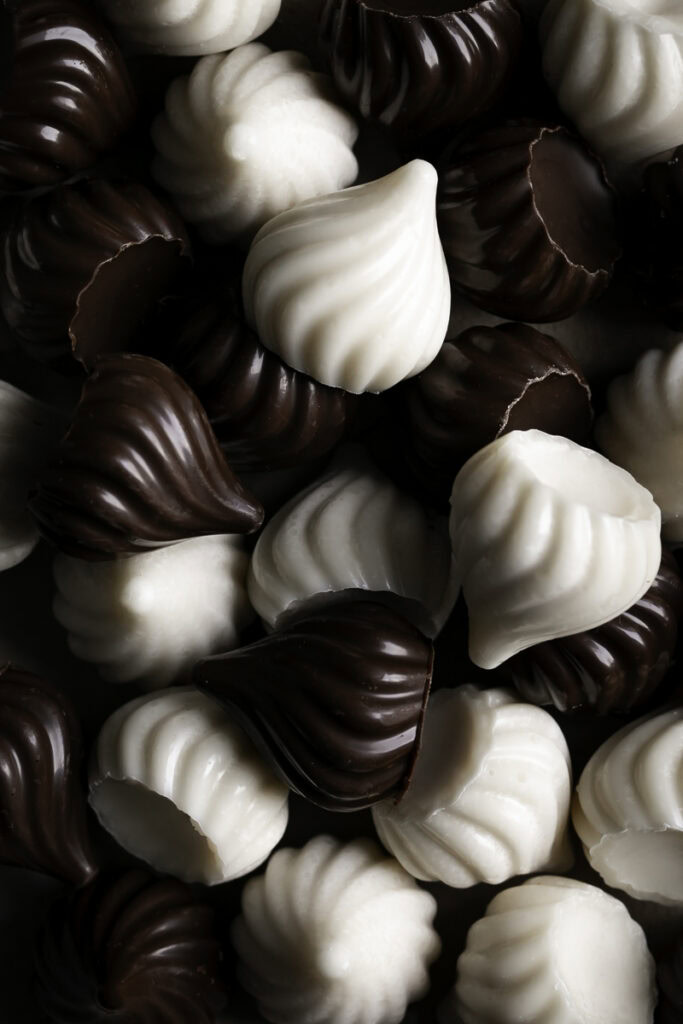chocolate and white chocolate candy kisses piled on top of one another.