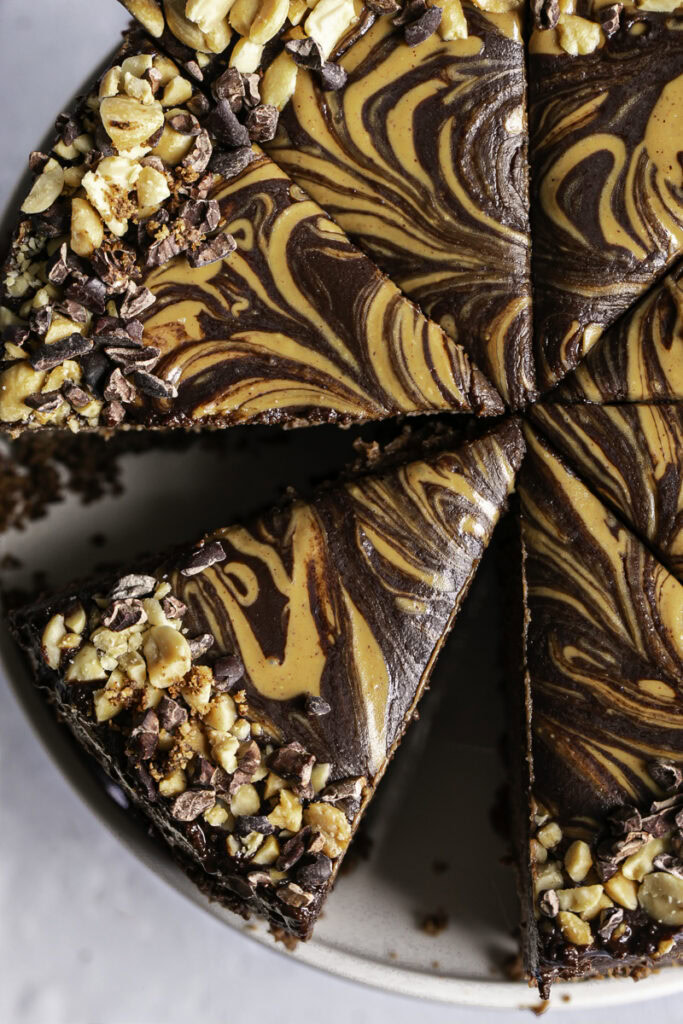 sliced overhead shot of vegan triple chocolate peanut butter cheesecake.